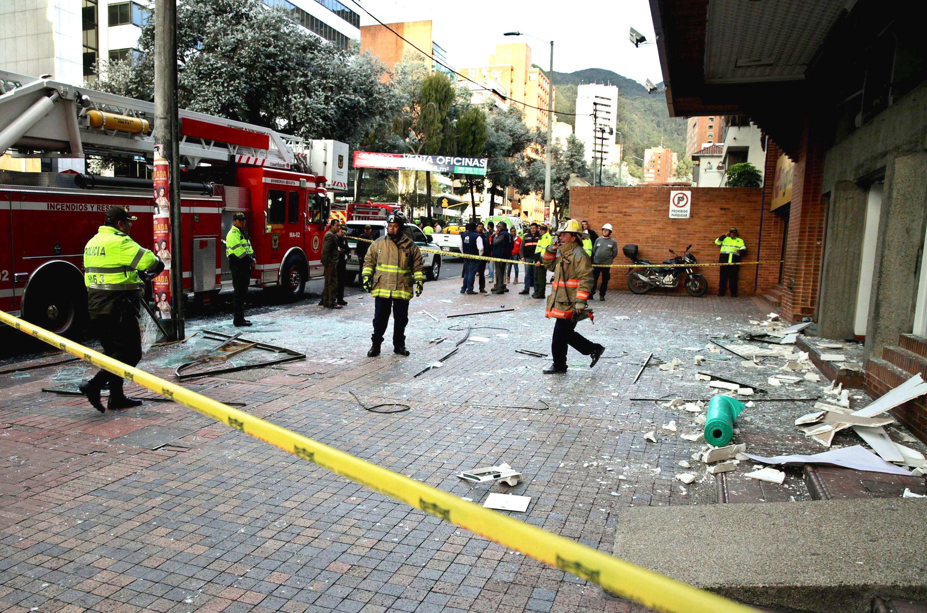 Firefighters work at the location where a device exploded in Bogota
