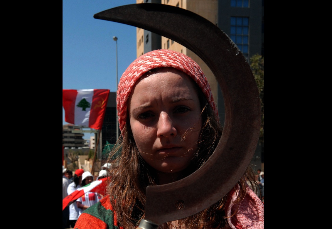 A Lebanese girl holds a sickle