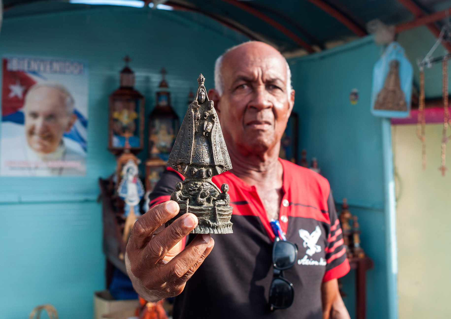 Cuban crafsman during Pope Francis' trip shows a copy of the statue of the Virgin of the Charity of El Cobre