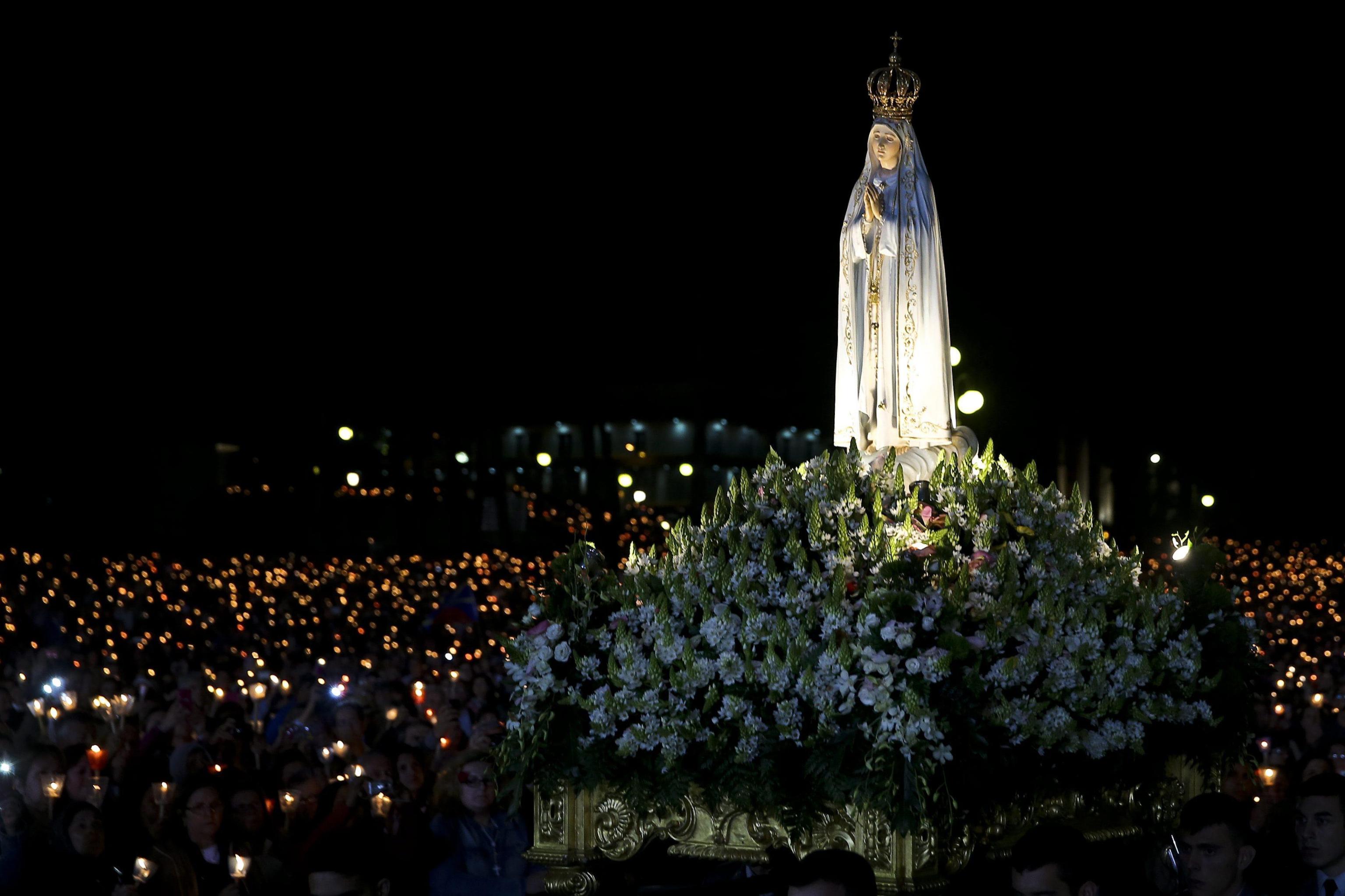 The image of Our Lady is transported among the faithfull in the Candles Procession during the annual 13th May pilgrimage to Fatima Sanctuary