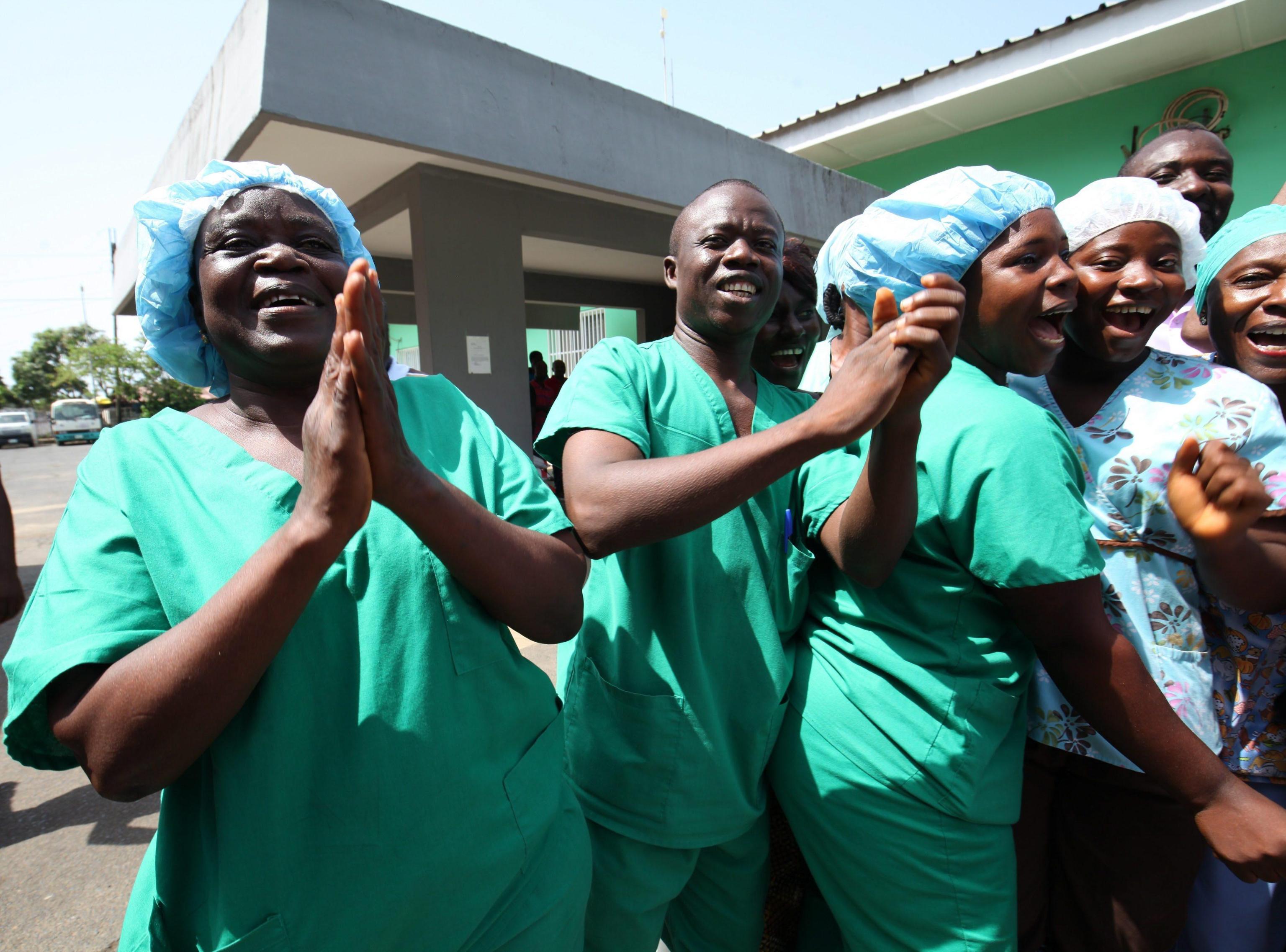 Nurses and doctors at St. Joseph's Catholic Hospital celebrate after the announcement that Liberia is ebola free