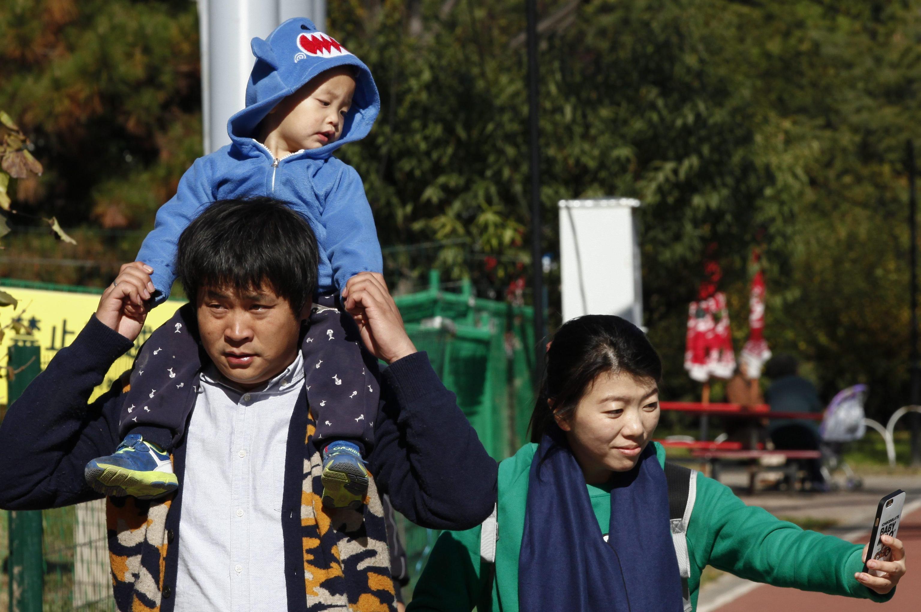 A Chinese family tours a public park in Beijing