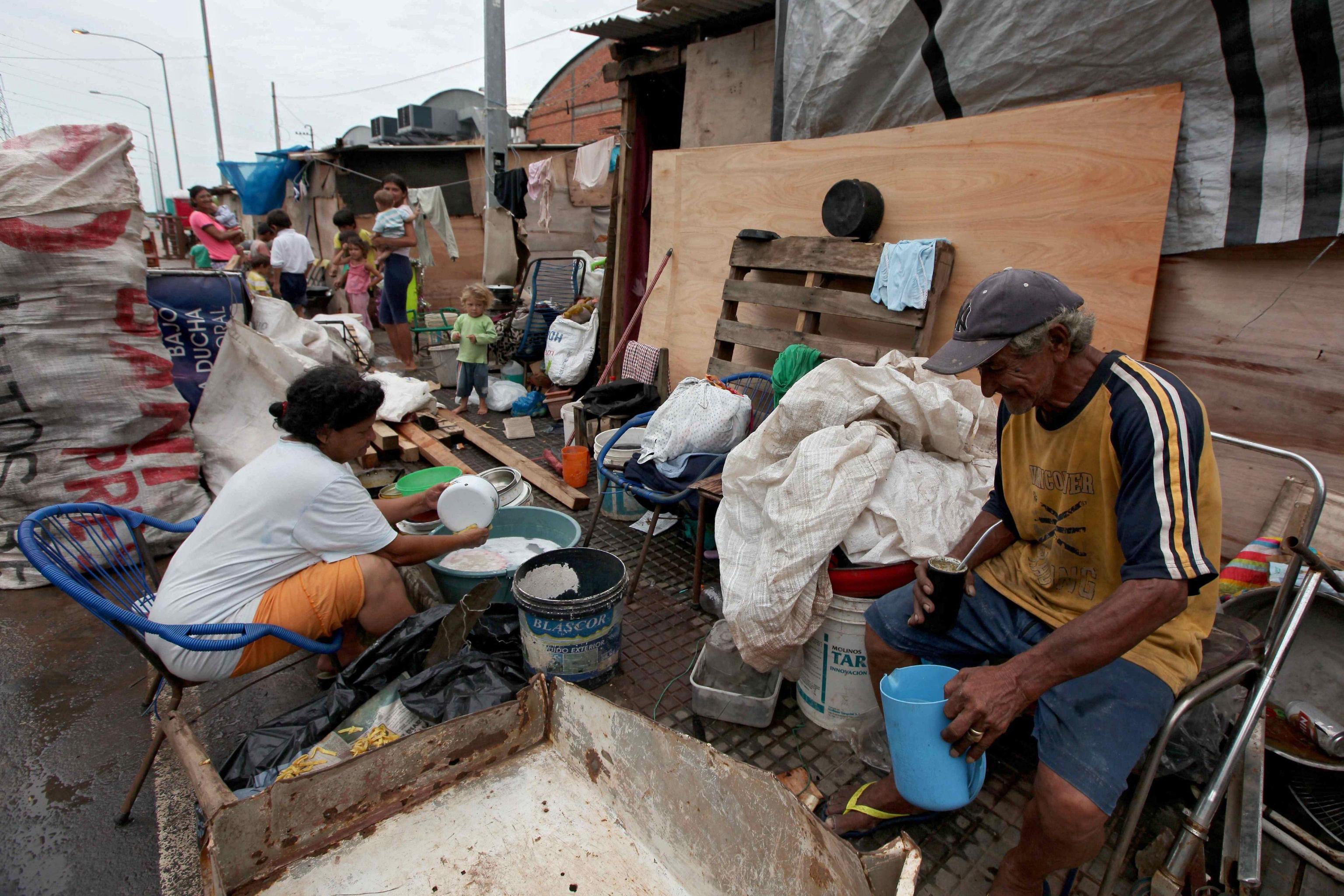 A family sits in a temporary shelter for affected people in Asuncion